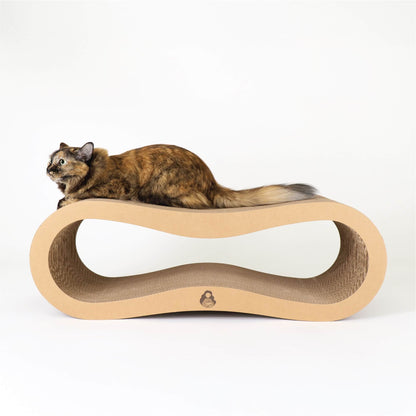 A Tortoiseshell Cat lounging on top of a big Infinity Cat Scratcher Board.