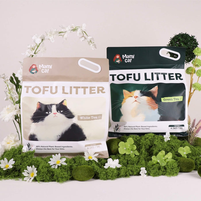 2 Bags of Mami Cat Tofu Litter White Tea Scent and Green Tea Scent with greeneries around, showcasing natural ingredients.